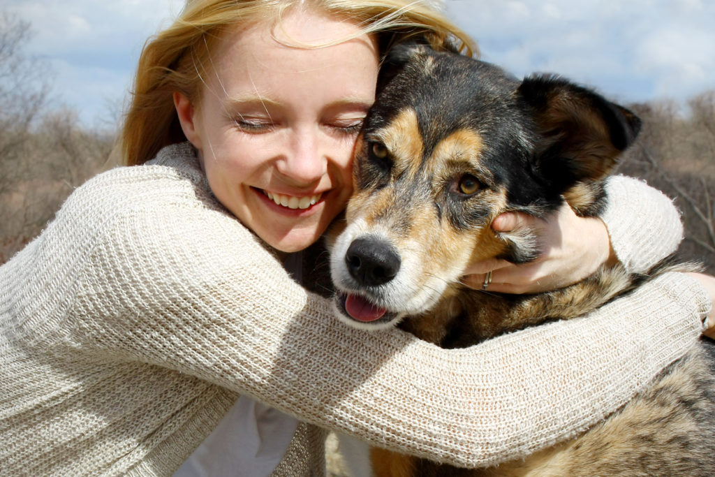 girl hugging dog with degenerative myelopathy